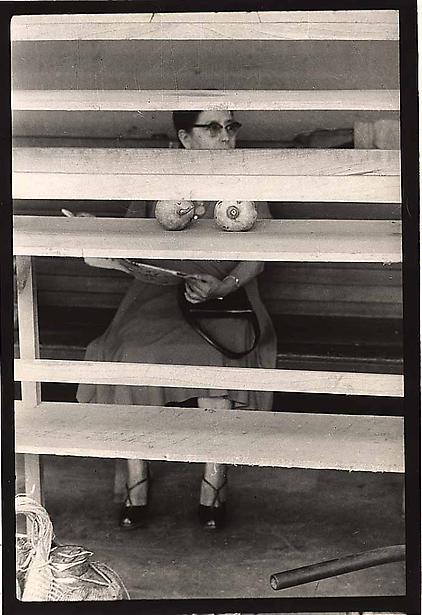 Elliot Erwitt photograph of woman with vegetables that look like breasts in front of her