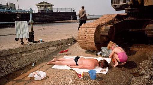 Martin Parr photograph of sunbathers near construction equipment